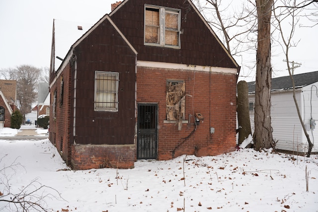 view of snow covered rear of property