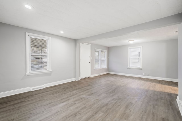 empty room with dark hardwood / wood-style flooring