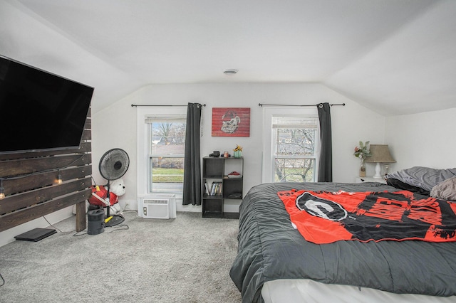 carpeted bedroom featuring lofted ceiling and an AC wall unit