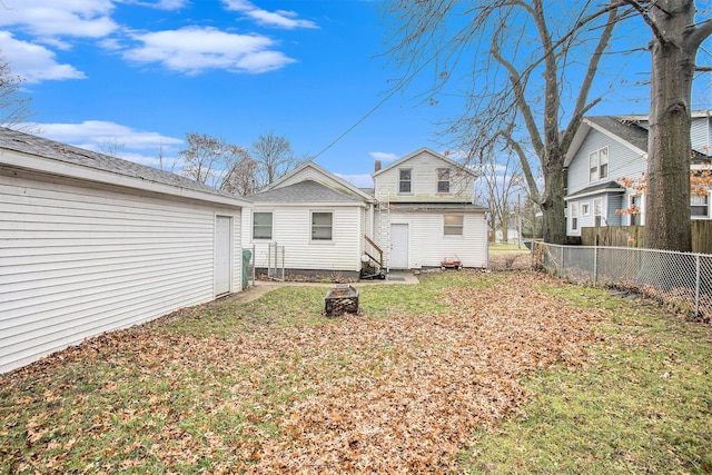 rear view of house featuring a yard