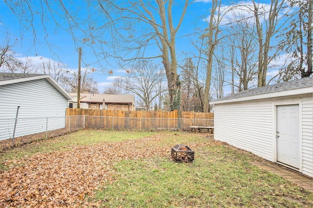 view of yard with a fire pit