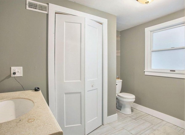 bathroom featuring vanity and toilet