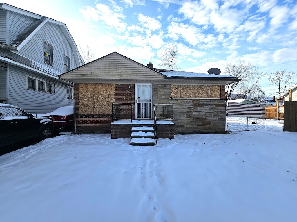 view of snow covered rear of property