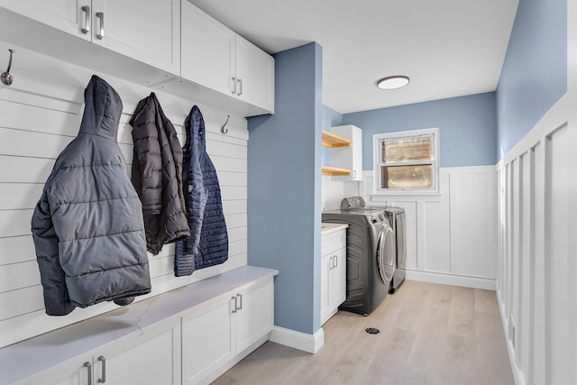 mudroom with washing machine and dryer and light hardwood / wood-style floors