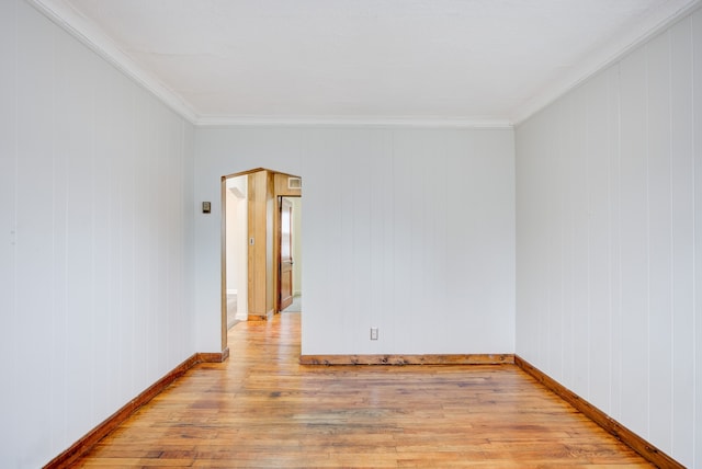 unfurnished room with crown molding and light hardwood / wood-style flooring