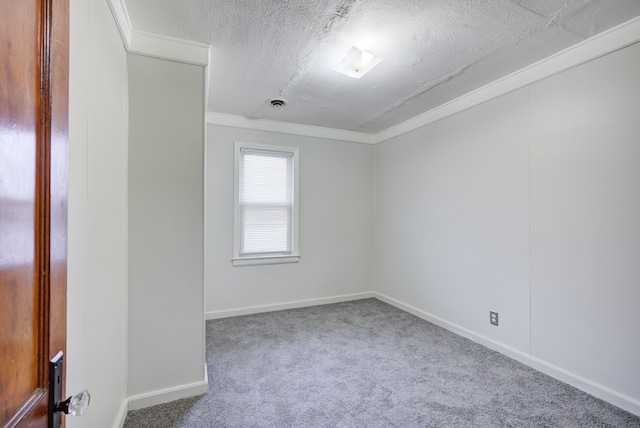 carpeted spare room with a textured ceiling and ornamental molding