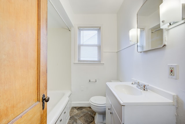 bathroom with a bathing tub, vanity, and toilet