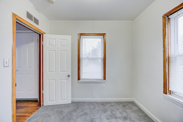 unfurnished bedroom with light colored carpet and ornamental molding