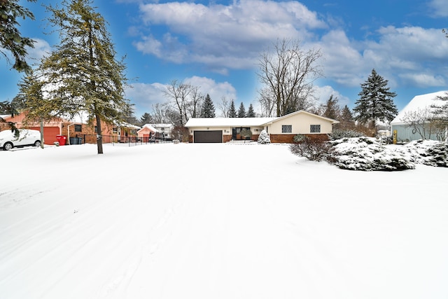 yard covered in snow featuring a garage