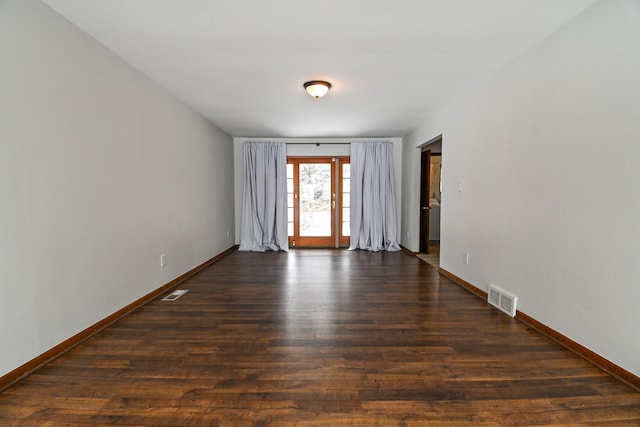 empty room featuring dark wood-type flooring