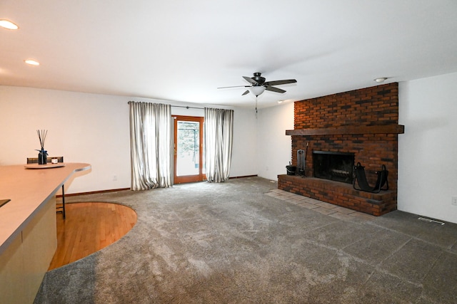 carpeted living room featuring ceiling fan and a fireplace