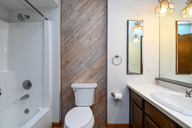 full bathroom featuring toilet, vanity, wood walls, and  shower combination