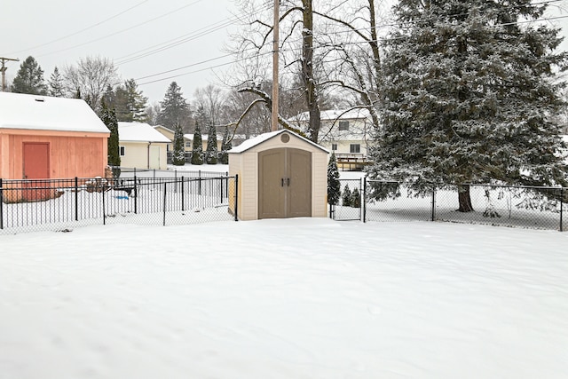 snowy yard with a shed