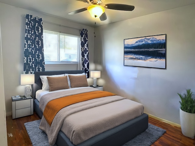 bedroom featuring ceiling fan and dark wood-type flooring