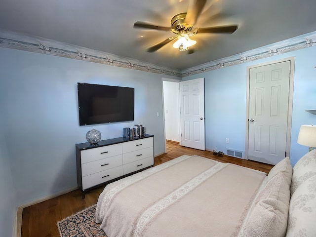 bedroom with ceiling fan and wood-type flooring