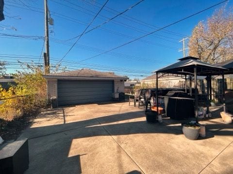 exterior space featuring a gazebo and a garage