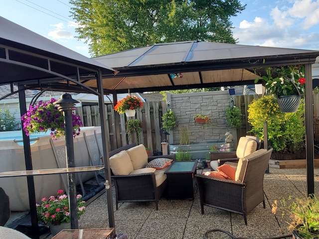 view of patio featuring outdoor lounge area and a gazebo