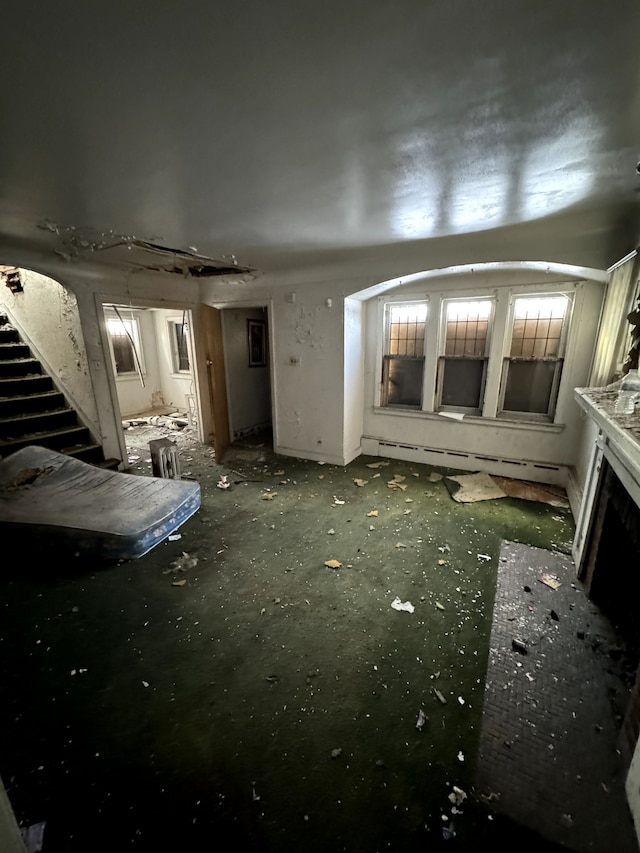 miscellaneous room with a baseboard heating unit and a fireplace