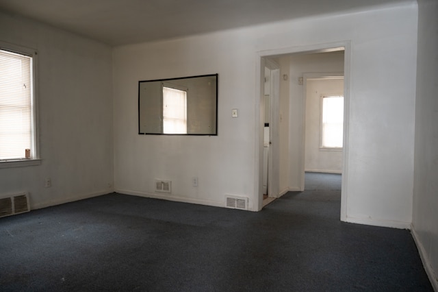 carpeted spare room with a healthy amount of sunlight