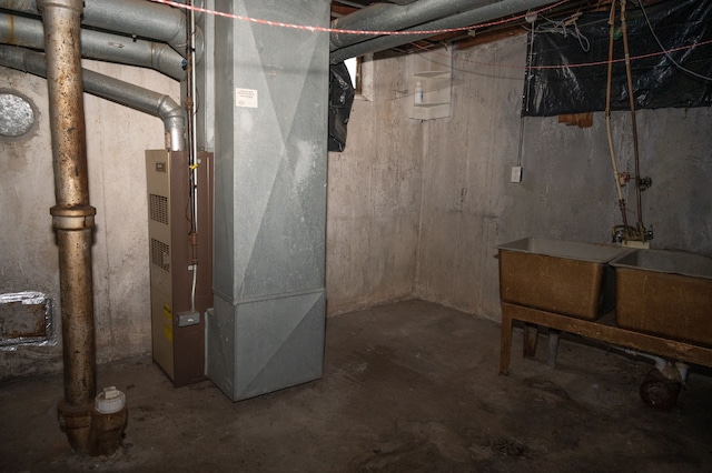 basement featuring sink and heating unit