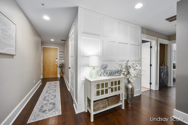 corridor featuring dark hardwood / wood-style floors and washer / clothes dryer