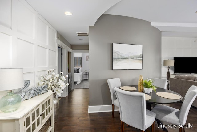 dining area featuring dark hardwood / wood-style floors