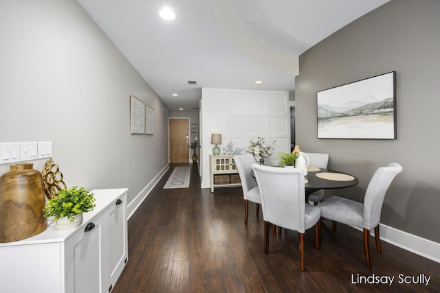 dining area with dark hardwood / wood-style floors