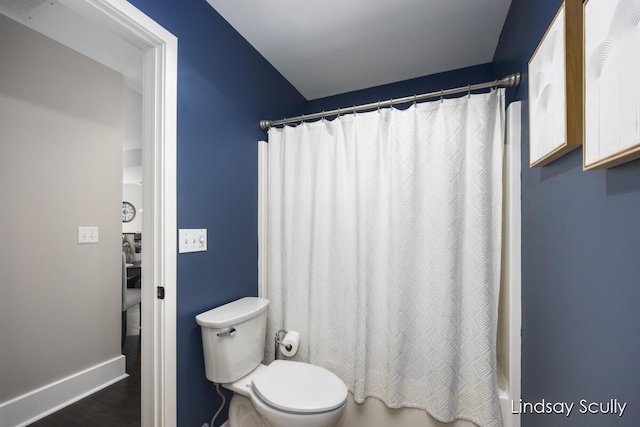 bathroom featuring shower / bath combination with curtain, hardwood / wood-style flooring, and toilet