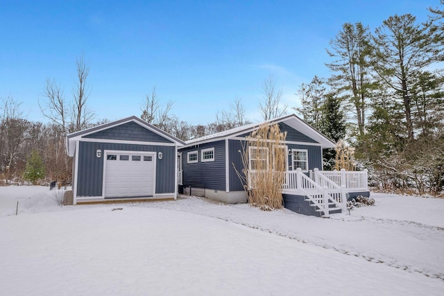 ranch-style house with a wooden deck, an outbuilding, and a garage