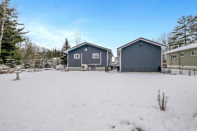 view of snow covered rear of property