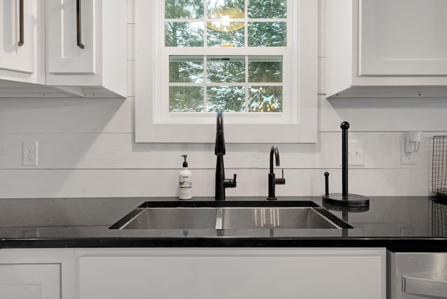 kitchen with backsplash, white cabinetry, a healthy amount of sunlight, and sink