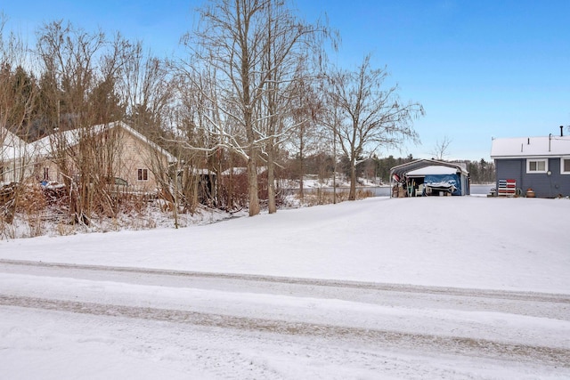 yard covered in snow with a carport