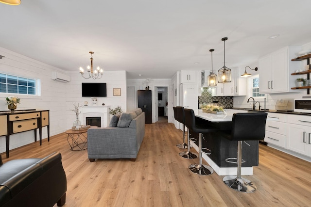 kitchen featuring white cabinets, a breakfast bar, a kitchen island, and hanging light fixtures