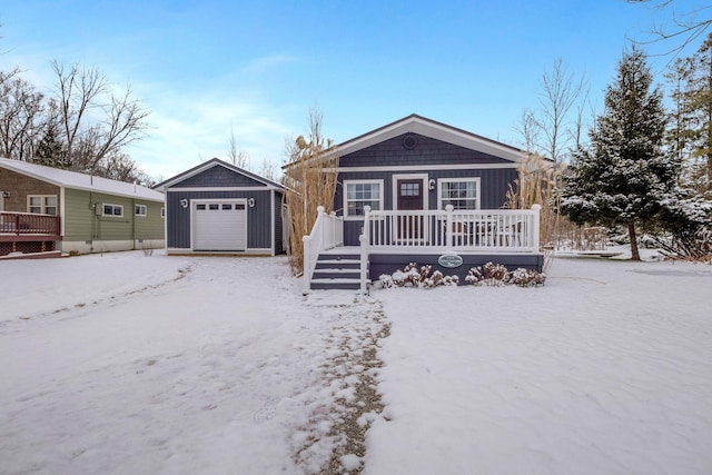 ranch-style house featuring a garage and an outbuilding