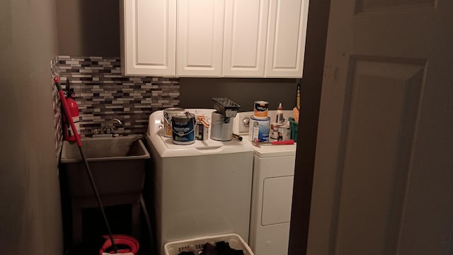 laundry area with separate washer and dryer and sink