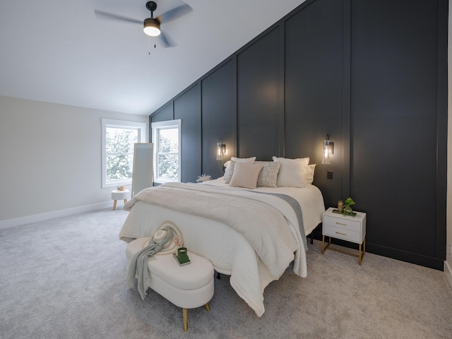 carpeted bedroom with ceiling fan and vaulted ceiling