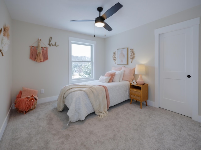 bedroom featuring ceiling fan and light carpet