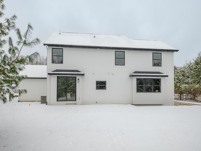 view of snow covered back of property