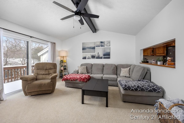 living room with ceiling fan, lofted ceiling with beams, and light carpet