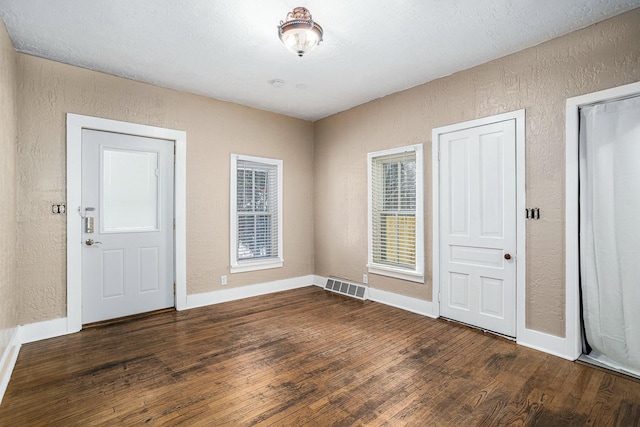 120 N Main St, Climax, MI 49034 - entryway featuring visible vents, baseboards, a textured wall, and wood finished floors