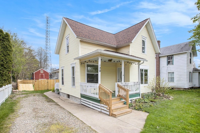 120 N Main St, Climax, MI 49034 - traditional-style house featuring roof with shingles, fence, a porch, and a front lawn