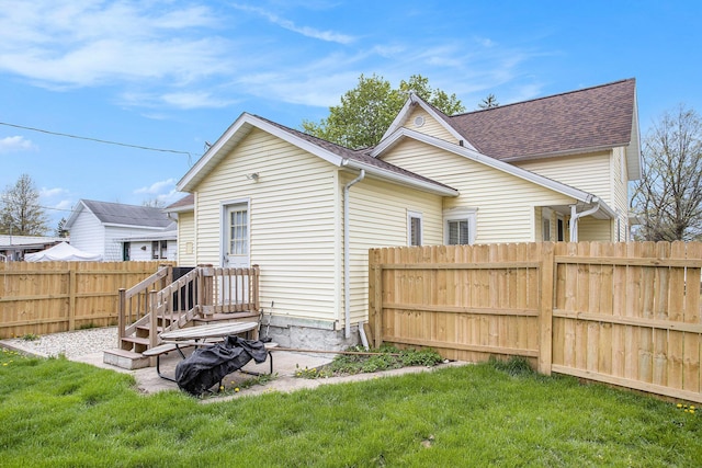 120 N Main St, Climax, MI 49034 - back of property featuring a fenced backyard, a shingled roof, and a yard