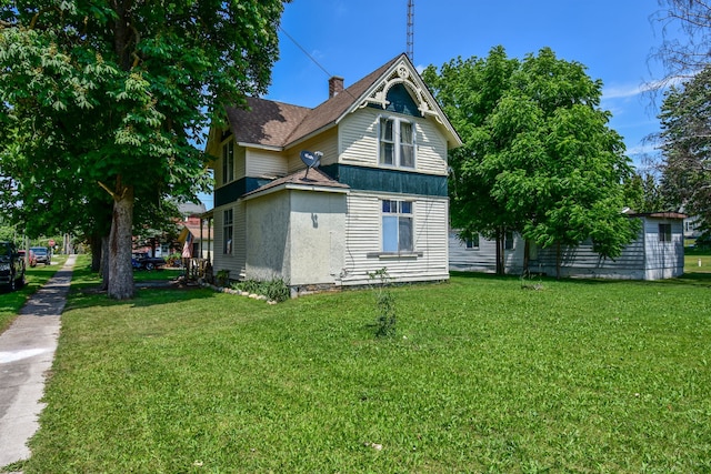 rear view of property featuring a yard