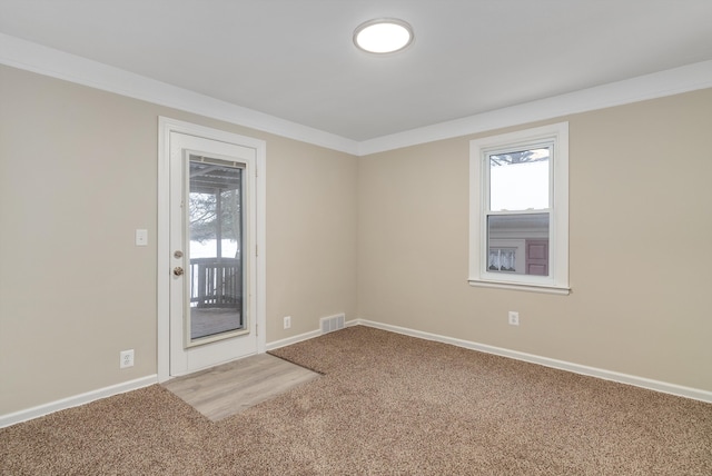 carpeted spare room with ornamental molding