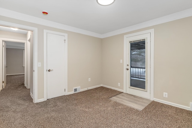 spare room with carpet flooring and crown molding