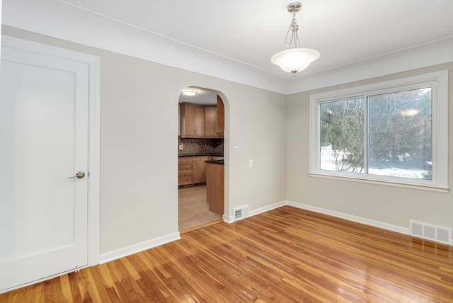 empty room with light hardwood / wood-style floors