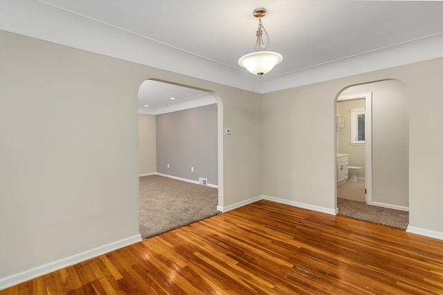 spare room with hardwood / wood-style floors