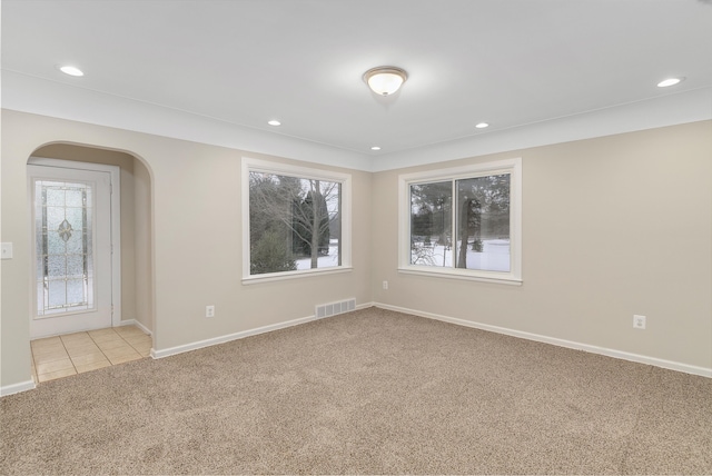 empty room with plenty of natural light and light carpet