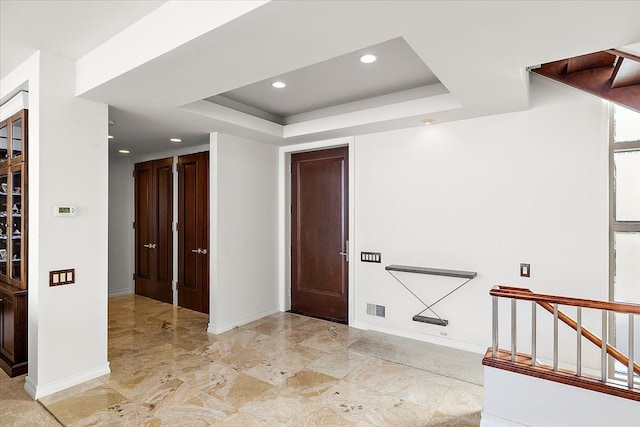 hallway featuring a raised ceiling