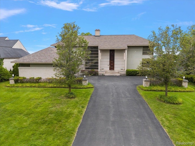 3468 Pine Estates Dr, West Bloomfield, MI 48323 - view of front facade with a front yard, a chimney, a shingled roof, and asphalt driveway